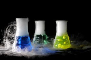 science experiment beakers with dry ice filling them