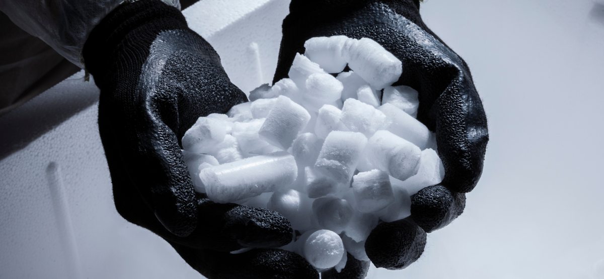 Dry Ice Pellets held with a pair of gloves