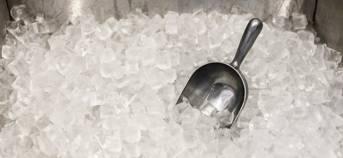 Metal ice scoop in ice bin